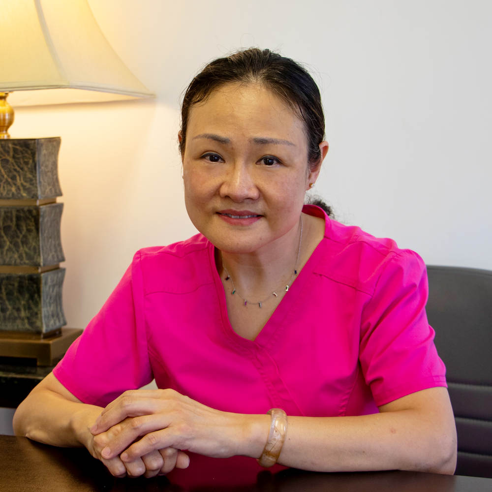 Dr. Pin Lu smiling in her Poway office